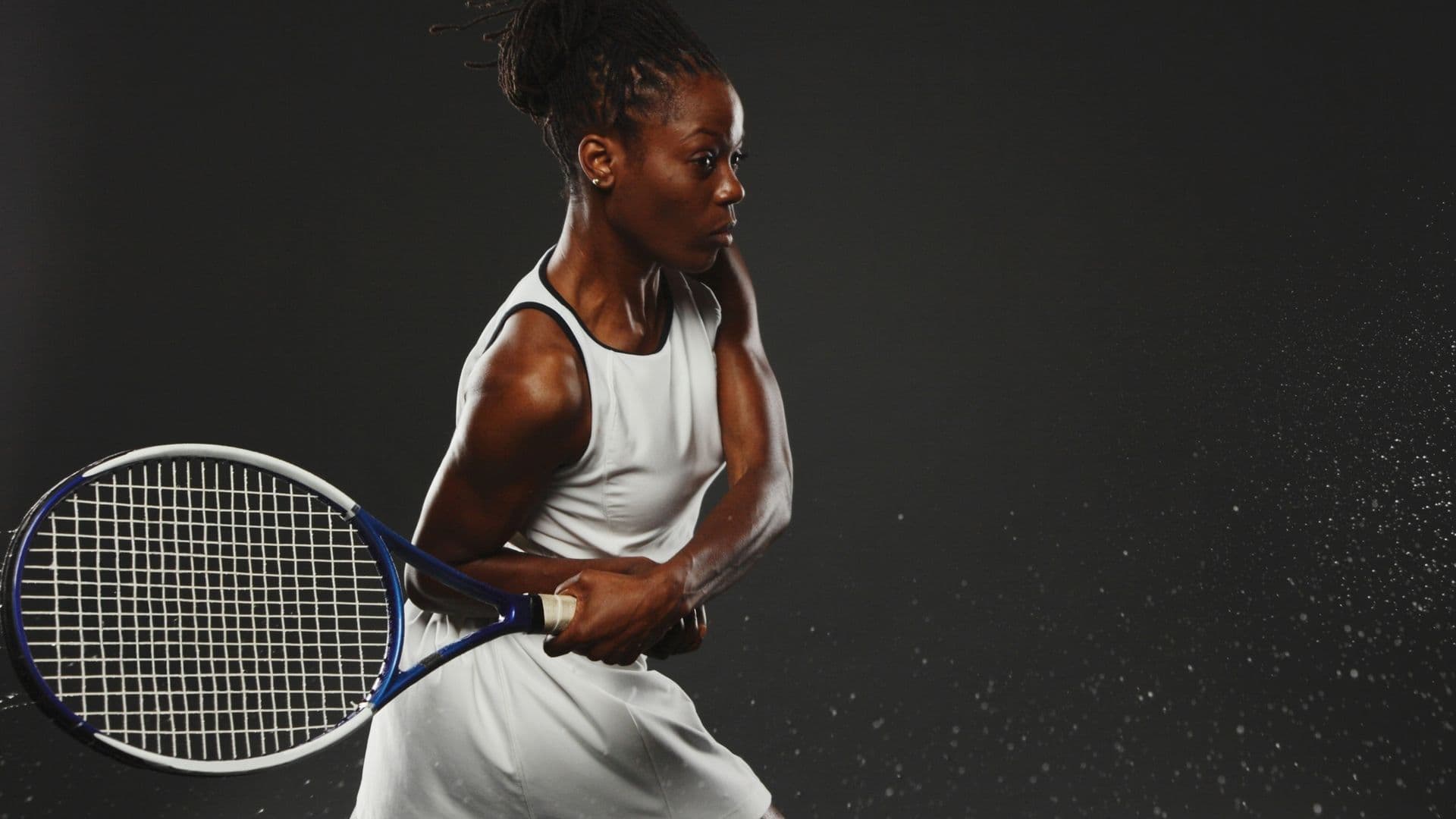 Tennis player preparing to serve on a competition court